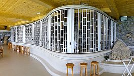 Long sliding shutter closing off a curved bar