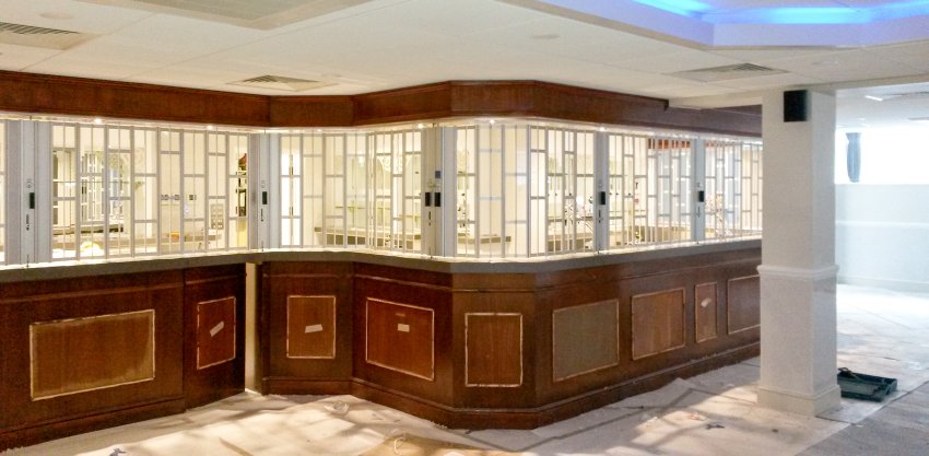 custom curve vision guard sliding grille at a reception counter
