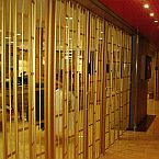 A Vision Guard sliding folding shutter in a gold finish installed at an international cruise ship.