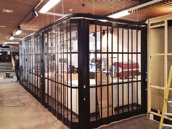 Curved sliding shutter in front of a coffee bar servery