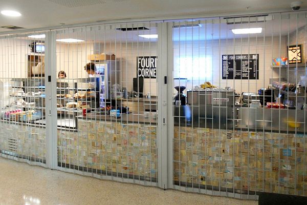 Open style sliding security shutter in front of a food-servery