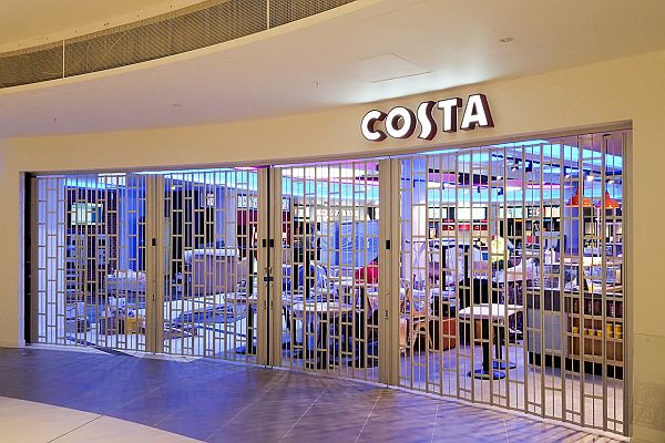 Long and wide, curved sliding security shutter closing off a costa shop
